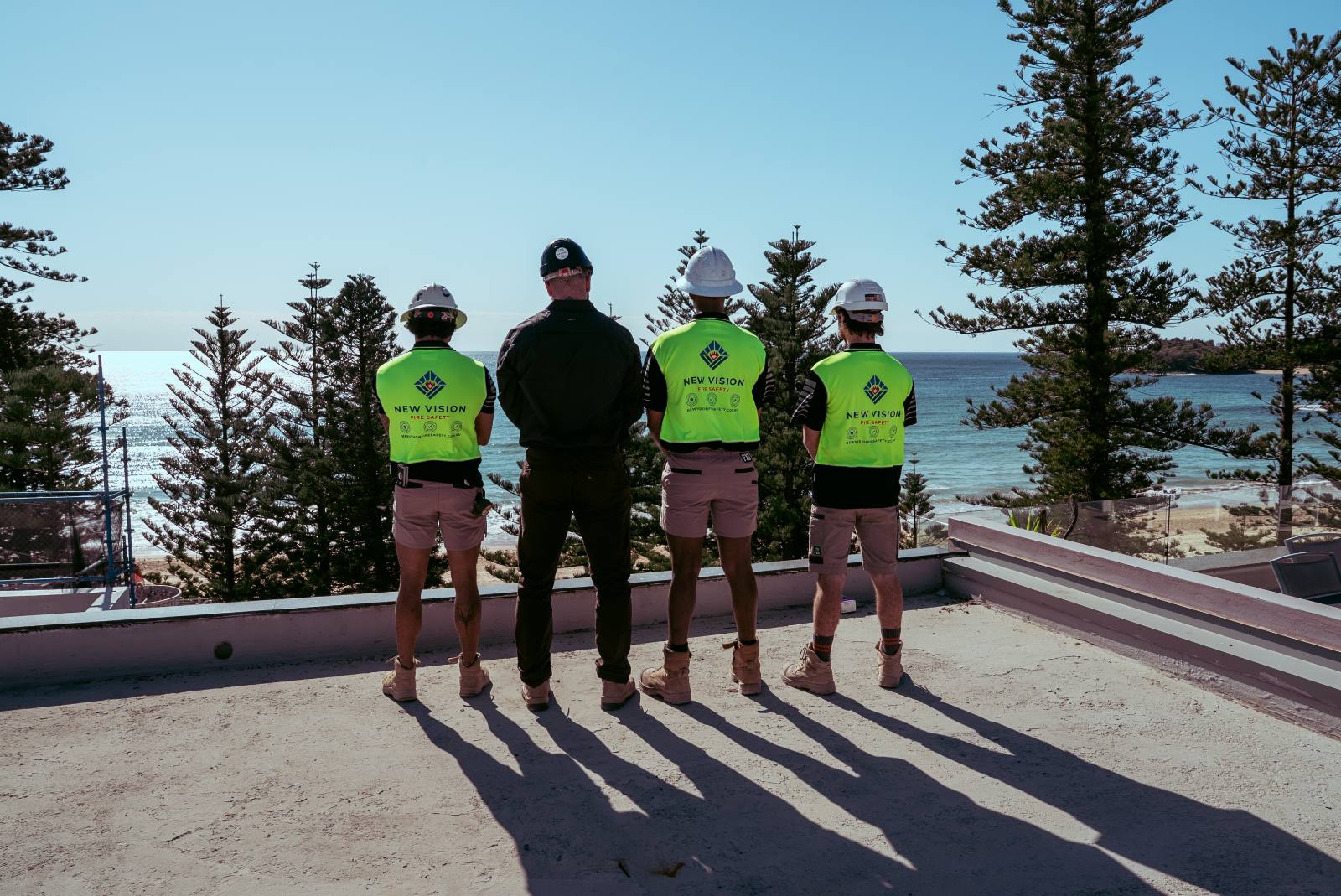 New Vision team overlooking Manly beach from the rooftop